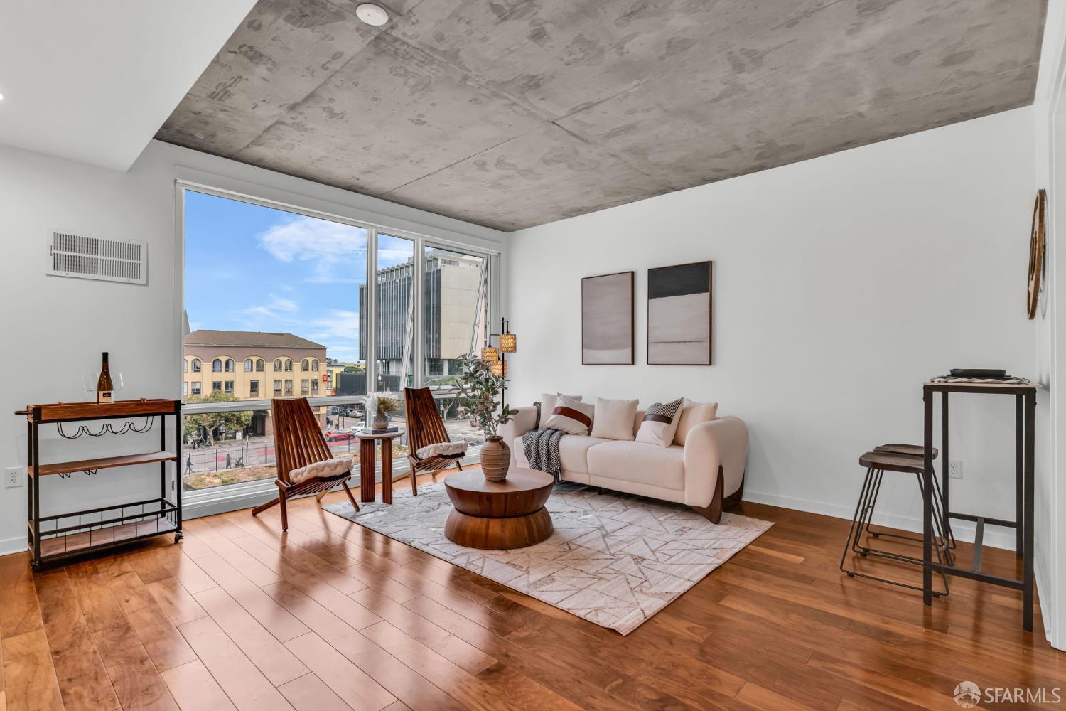 45 Bartlett Street, Unit 416 San Francisco, CA 94110 - Photo 3 of 36 a living room with furniture and a wooden floor