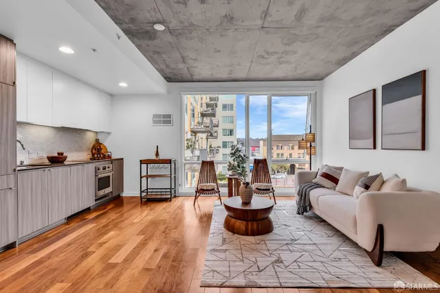 a living room with furniture and a wooden floor