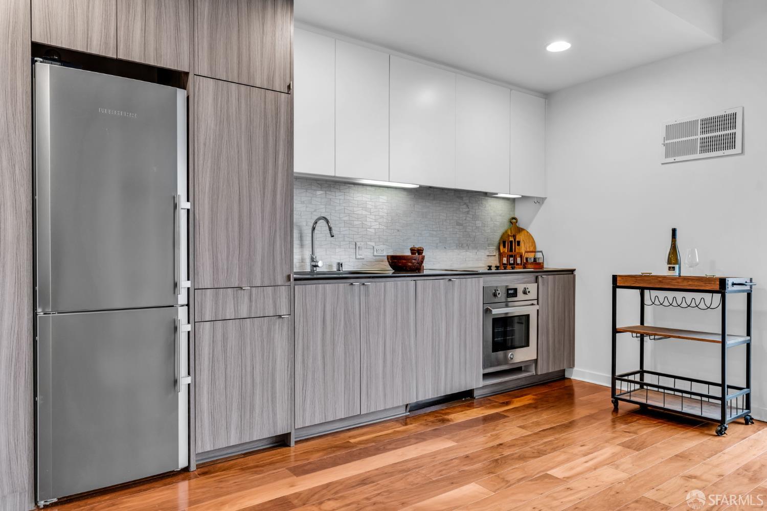 45 Bartlett Street, Unit 416 San Francisco, CA 94110 - Photo 7 of 36 a kitchen with stainless steel appliances a refrigerator and a stove top oven