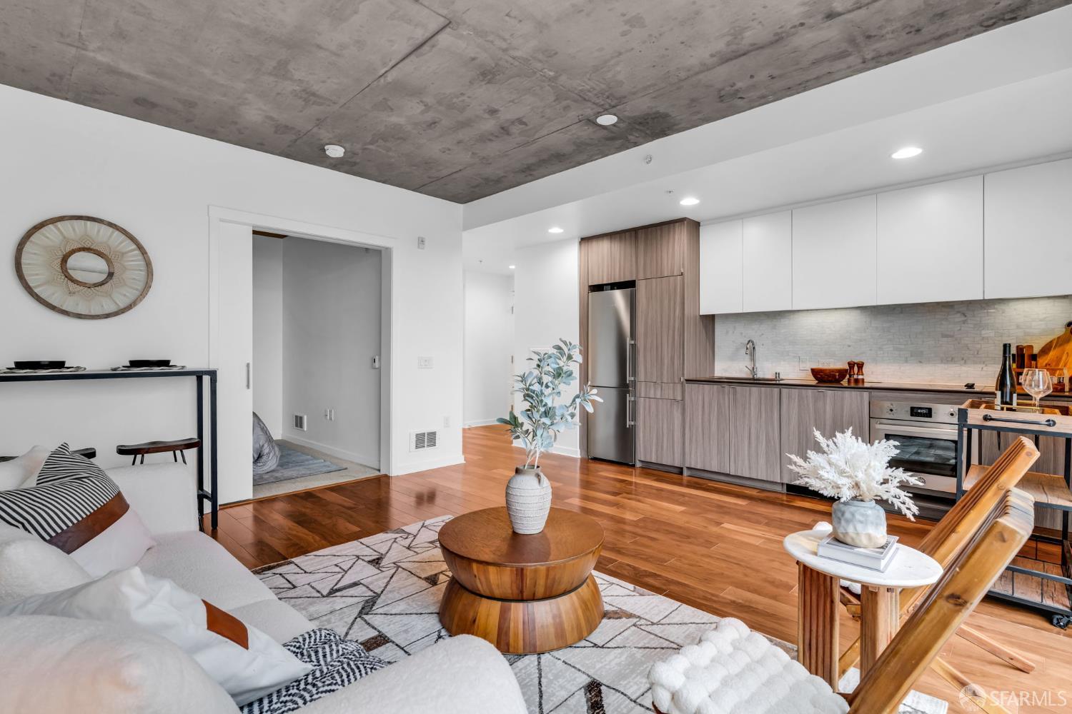 45 Bartlett Street, Unit 416 San Francisco, CA 94110 - Photo 9 of 36 a living room with furniture and a wooden floor
