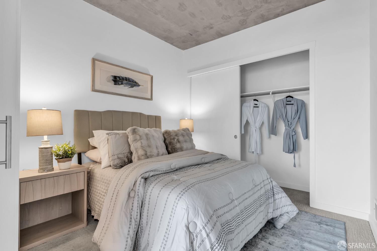 45 Bartlett Street, Unit 416 San Francisco, CA 94110 - Photo 10 of 36 a bedroom with a bed and lamp