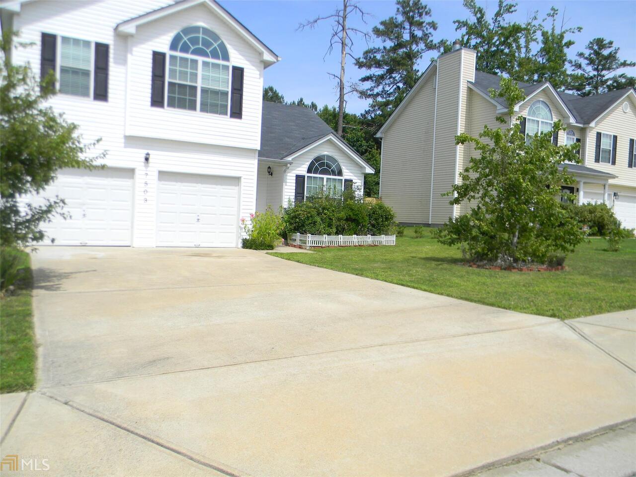 7503 Congregation Street Fairburn, GA 30213 - Photo 1 of 1 a front view of a house with a yard and garage