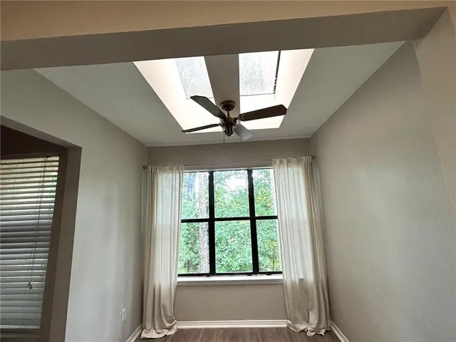 a view of a livingroom with a ceiling fan and window