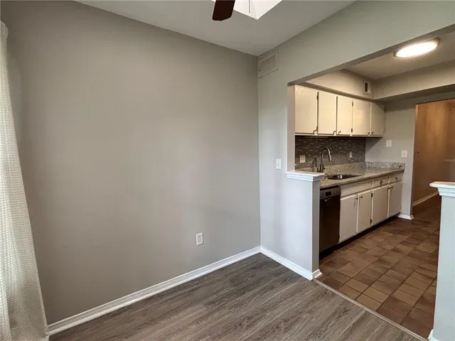 a kitchen with a sink a stove and cabinets