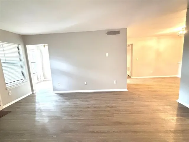 a view of a room with wooden floor