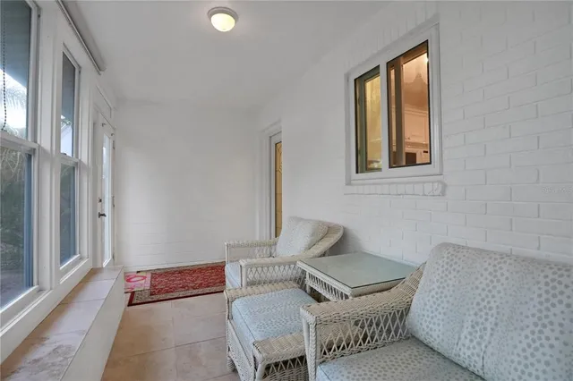 a bedroom with a bed chandelier and a window
