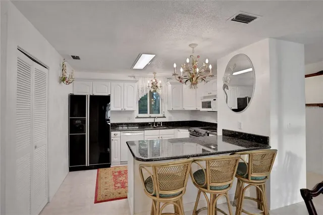 a bathroom with a toilet a sink a vanity and mirror