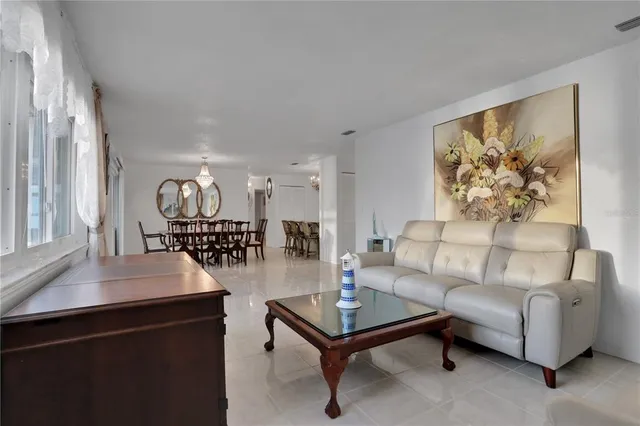 a view of an empty room with a floor to ceiling window and wooden floor