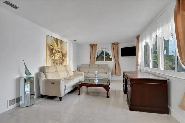 a view of a house with a yard and potted plants