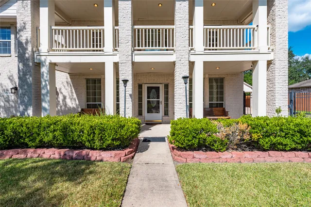 a view of a hallway with wooden floor and windows