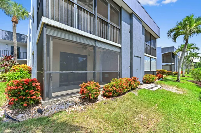 a view of a house with a yard and garden