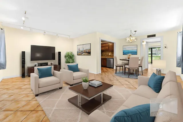 a living room with furniture a table and a flat screen tv