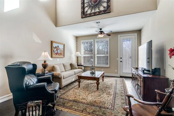 a living room with furniture or chandelier and a flat screen tv