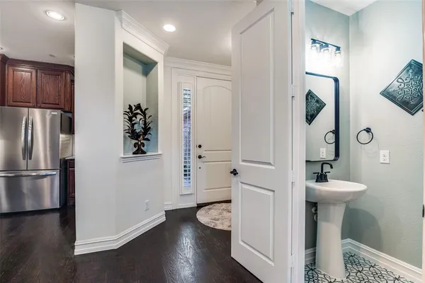 a bathroom with a sink mirror and toilet