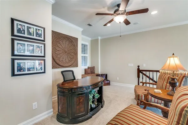 a living room with furniture and a baby crib