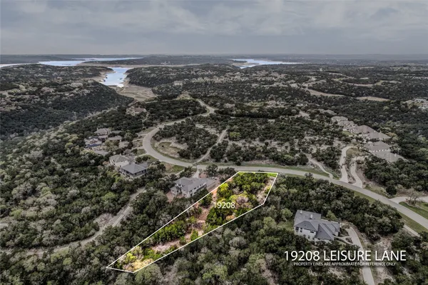 an aerial view of house with yard and mountain view in back