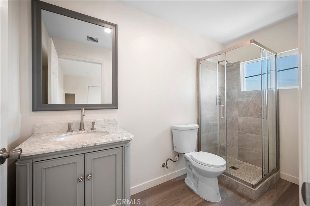 8435 Rincon Avenue Sun Valley, CA 91352 - Photo 50 of 61 a bathroom with a toilet sink vanity and shower