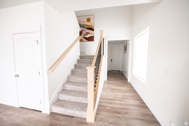 384 Ropelato Drive Nibley, UT 84321 - Photo 10 of 25 Staircase featuring wood finished floors and baseboards