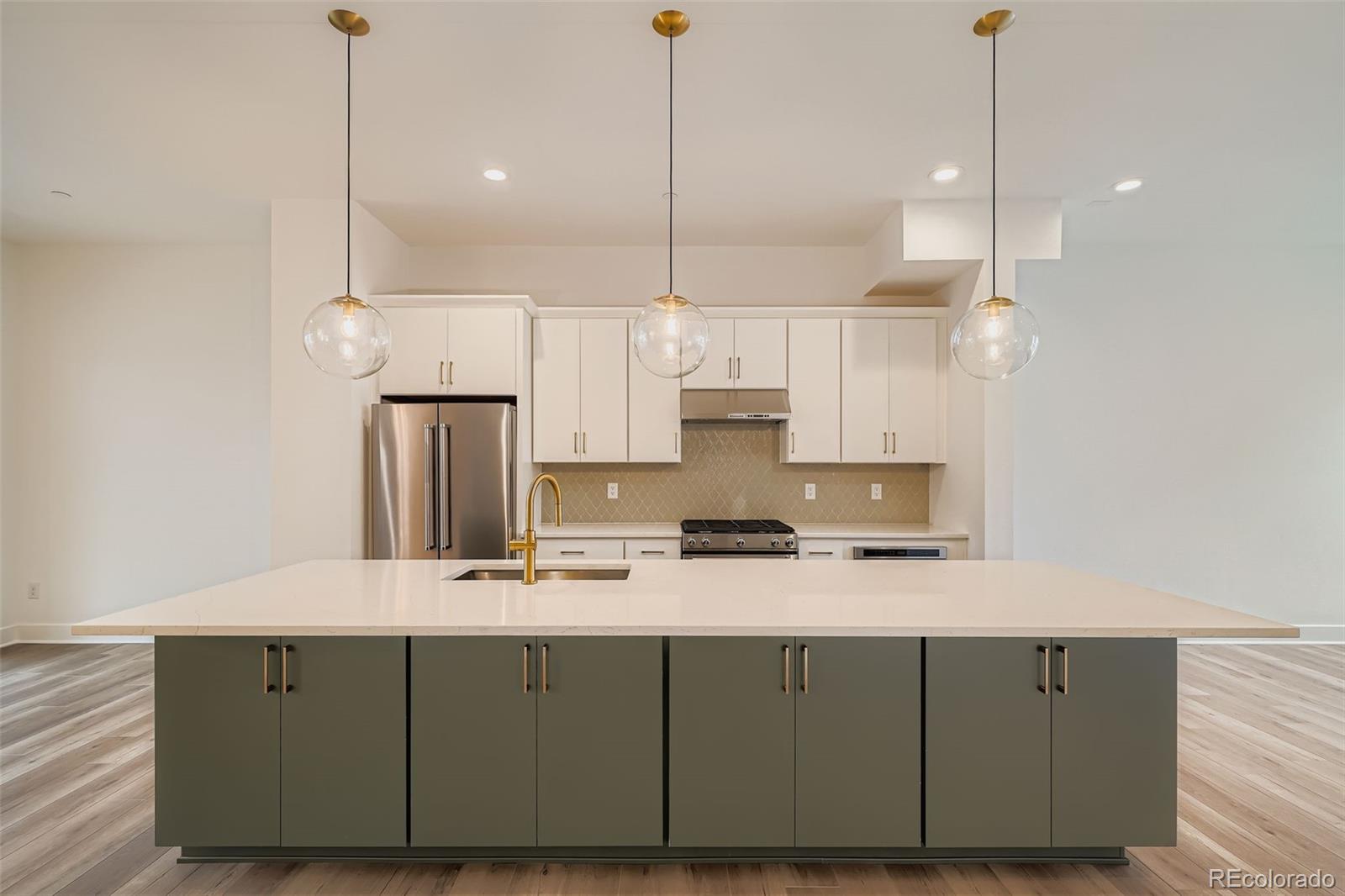 765 Superior Drive Superior, CO 80027 - Photo 11 of 32 a kitchen with kitchen island granite countertop a sink a counter space appliances and cabinets