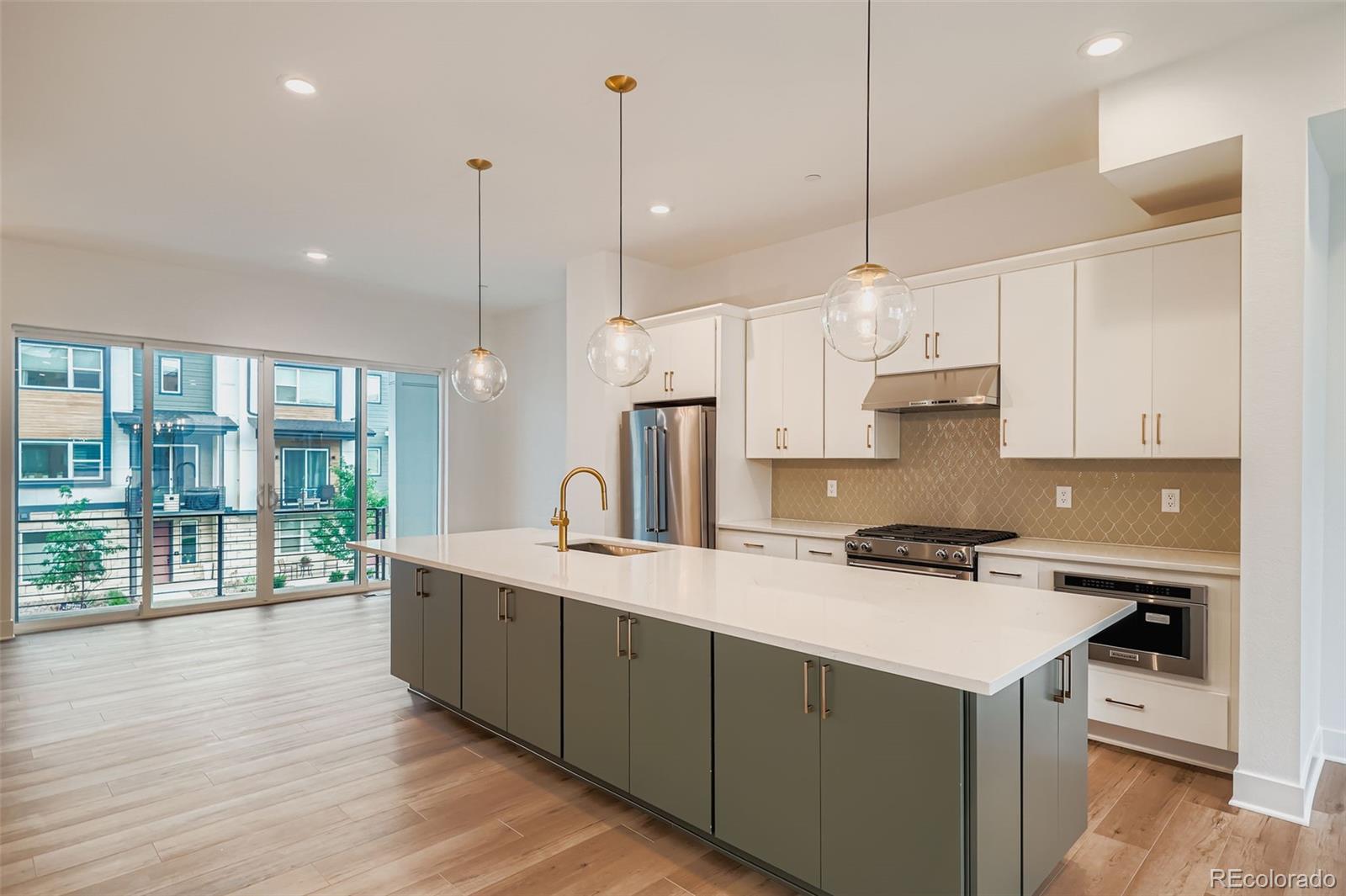 765 Superior Drive Superior, CO 80027 - Photo 12 of 32 a kitchen with stainless steel appliances granite countertop a sink a stove and a wooden floor
