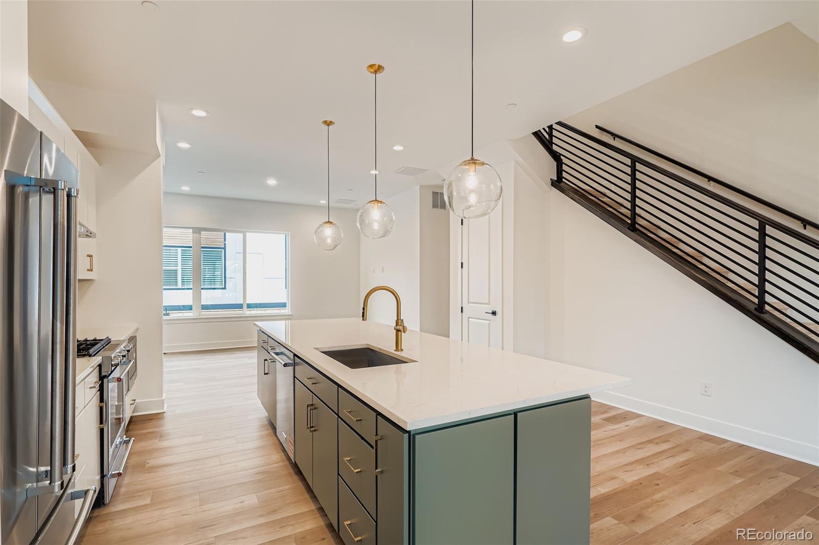 765 Superior Drive Superior, CO 80027 - Photo 14 of 32 a kitchen with a sink a faucet a stove and wooden floor