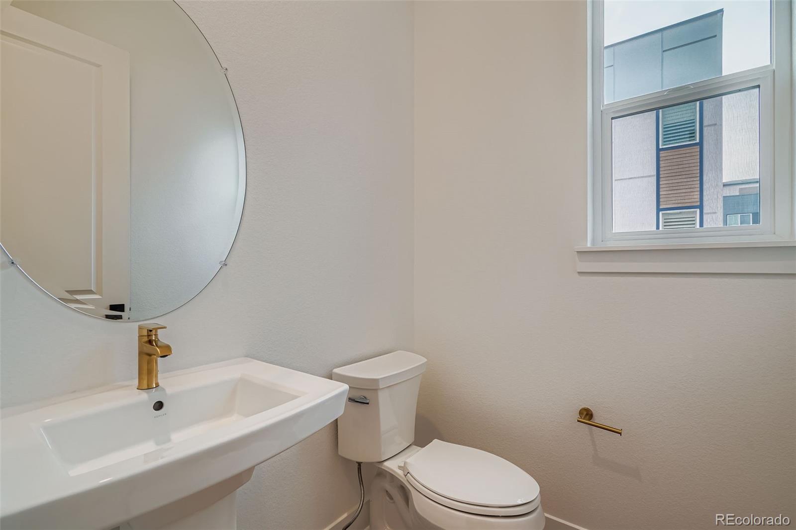 765 Superior Drive Superior, CO 80027 - Photo 15 of 32 a bathroom with a sink a toilet and mirror