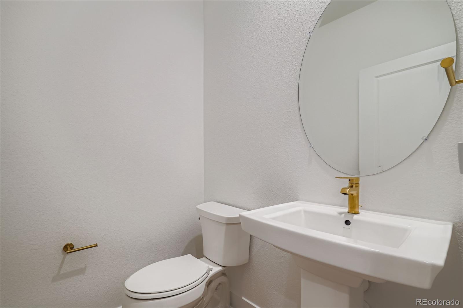765 Superior Drive Superior, CO 80027 - Photo 26 of 32 a bathroom with a sink a toilet and a mirror