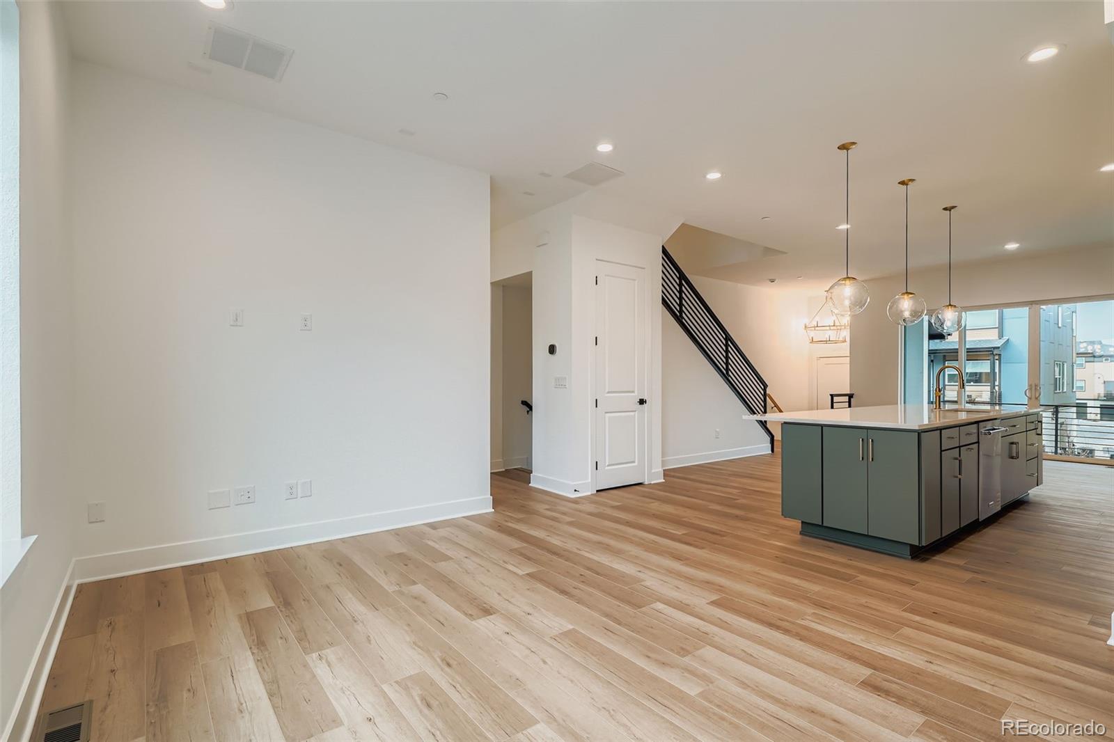 765 Superior Drive Superior, CO 80027 - Photo 6 of 32 a view of an empty room with wooden floor and stairs