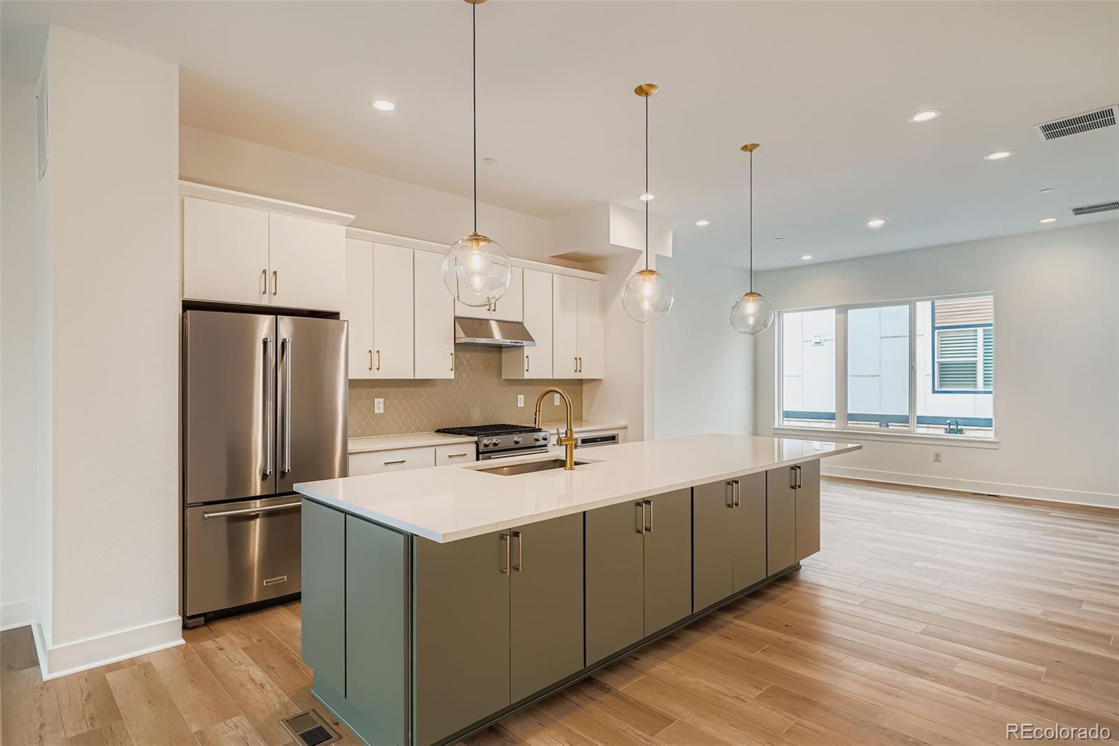 765 Superior Drive Superior, CO 80027 - Photo 10 of 32 a kitchen with a refrigerator a sink and wooden floor