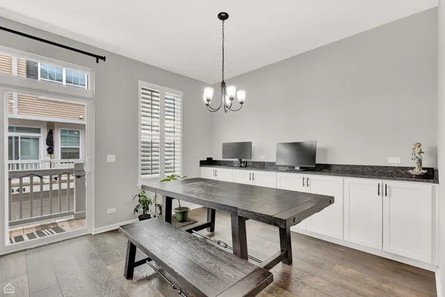 a workspace with furniture window and wooden floor