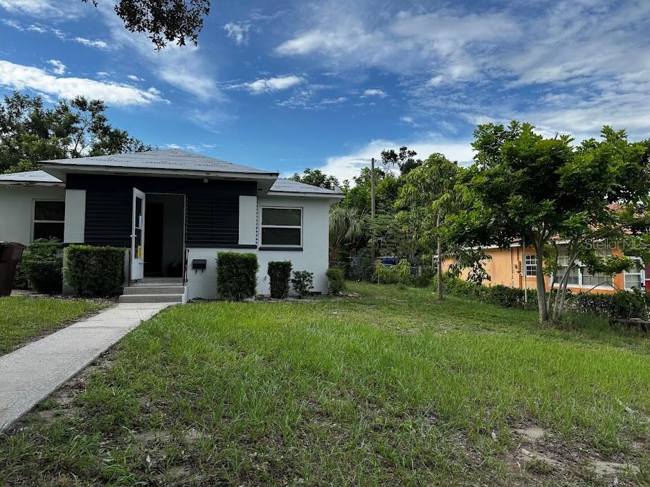 a front view of a house with a garden