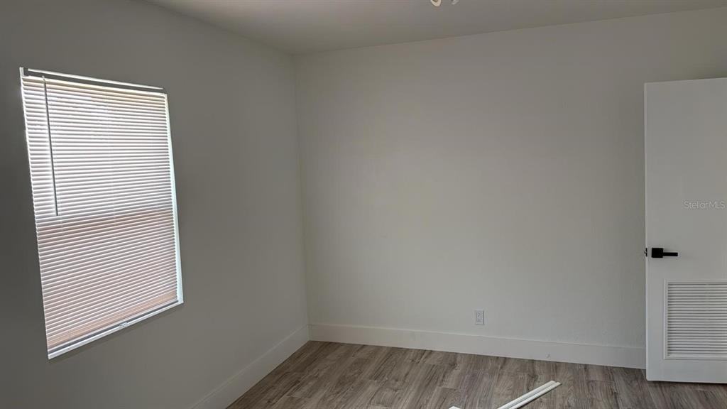 311 Osceola Avenue Lake Wales, FL 33853 - Photo 4 of 4 a view of a small space with wooden floor and a window