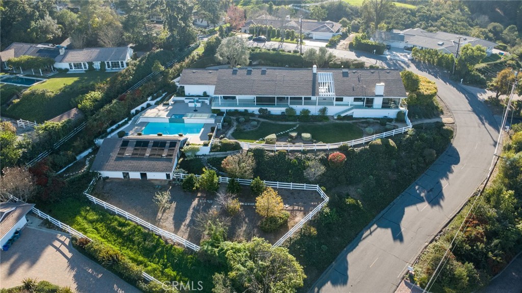 an aerial view of a house with a garden and lake view