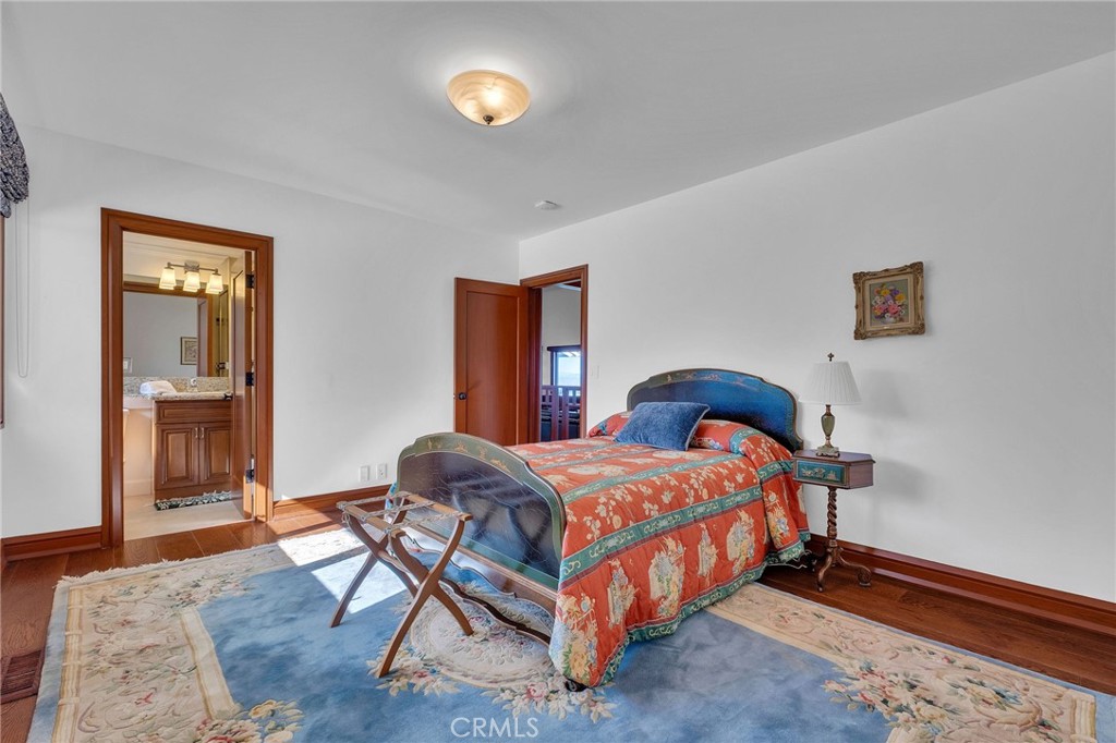 15 Caballeros Road Rolling Hills, CA 90274 - Photo 39 of 70 a bedroom with a bed and wooden floor
