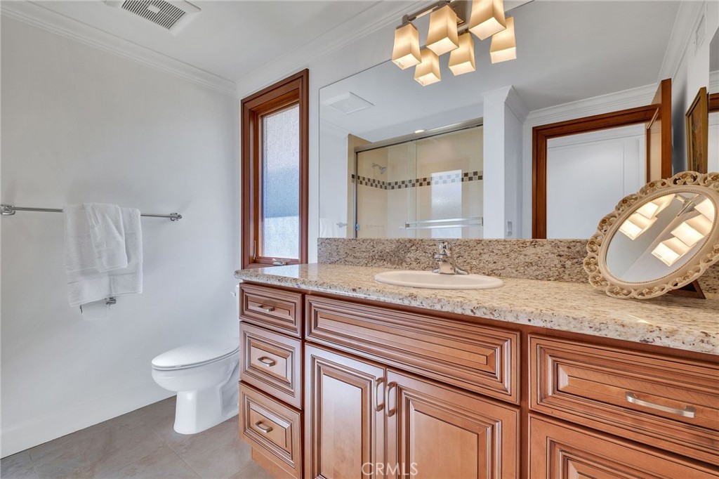 15 Caballeros Road Rolling Hills, CA 90274 - Photo 43 of 70 a bathroom with a granite countertop sink a toilet and a mirror