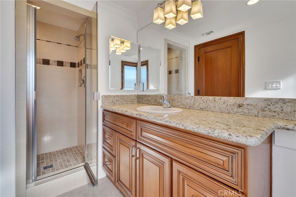 15 Caballeros Road Rolling Hills, CA 90274 - Photo 48 of 70 a bathroom with a granite countertop sink a mirror and a shower