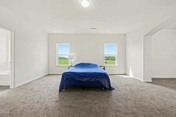 a bed room with a bed and a window