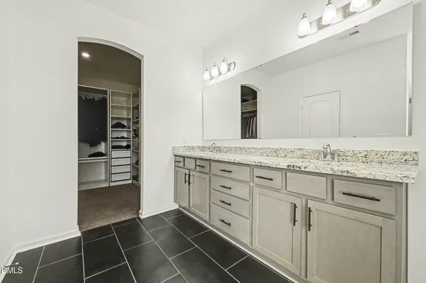 a bathroom with a granite countertop sink a mirror and a