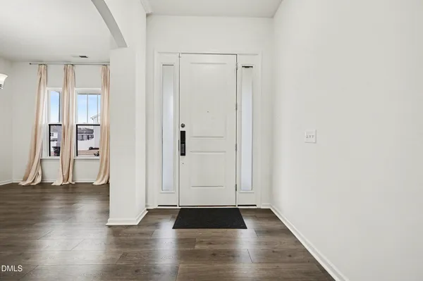 a view of an empty room and wooden floor