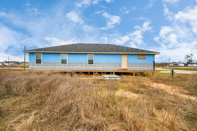 an aerial view of a house with a yard