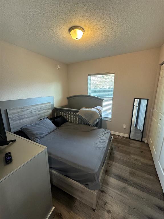 13183 Southwest 113th Place Dunnellon, FL 34432 - Photo 11 of 22 a bedroom with a bed and wooden floor