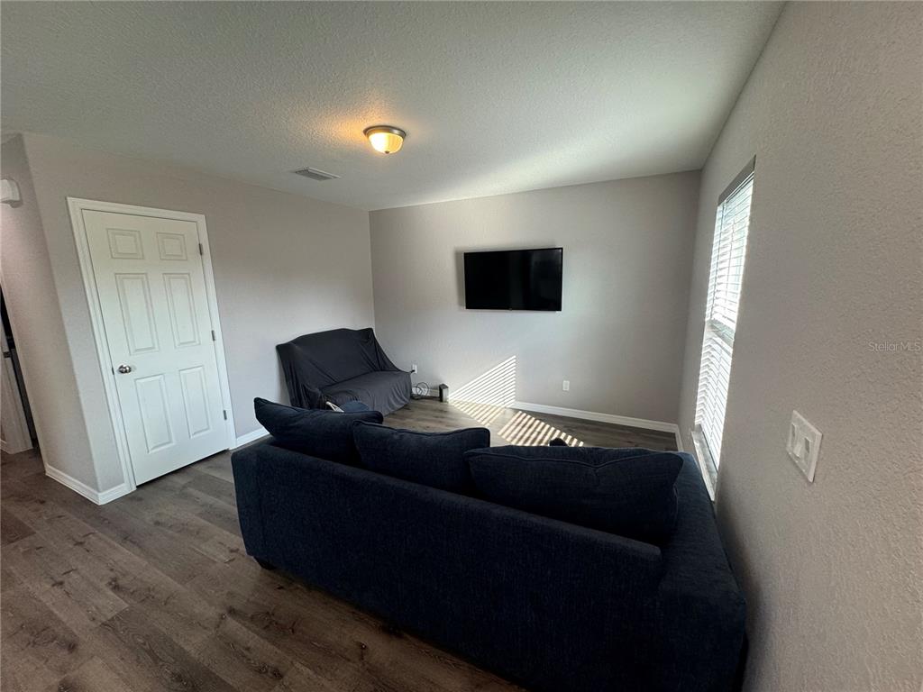 13183 Southwest 113th Place Dunnellon, FL 34432 - Photo 17 of 22 a living room with furniture and a flat screen tv