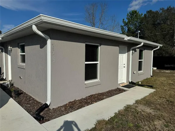 a front view of a house with trees