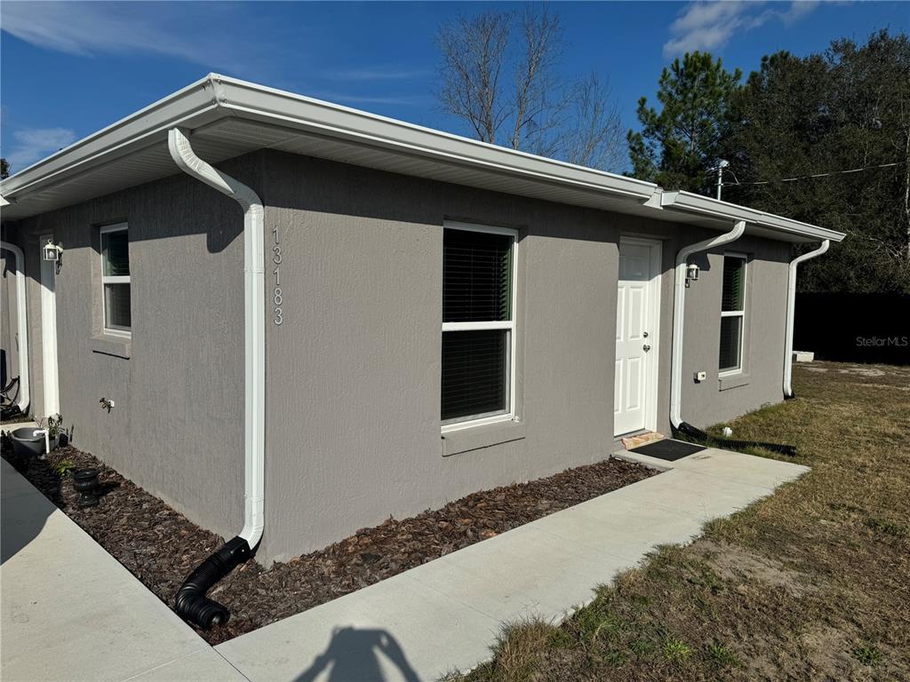 13183 Southwest 113th Place Dunnellon, FL 34432 - Photo 2 of 22 a front view of a house with trees