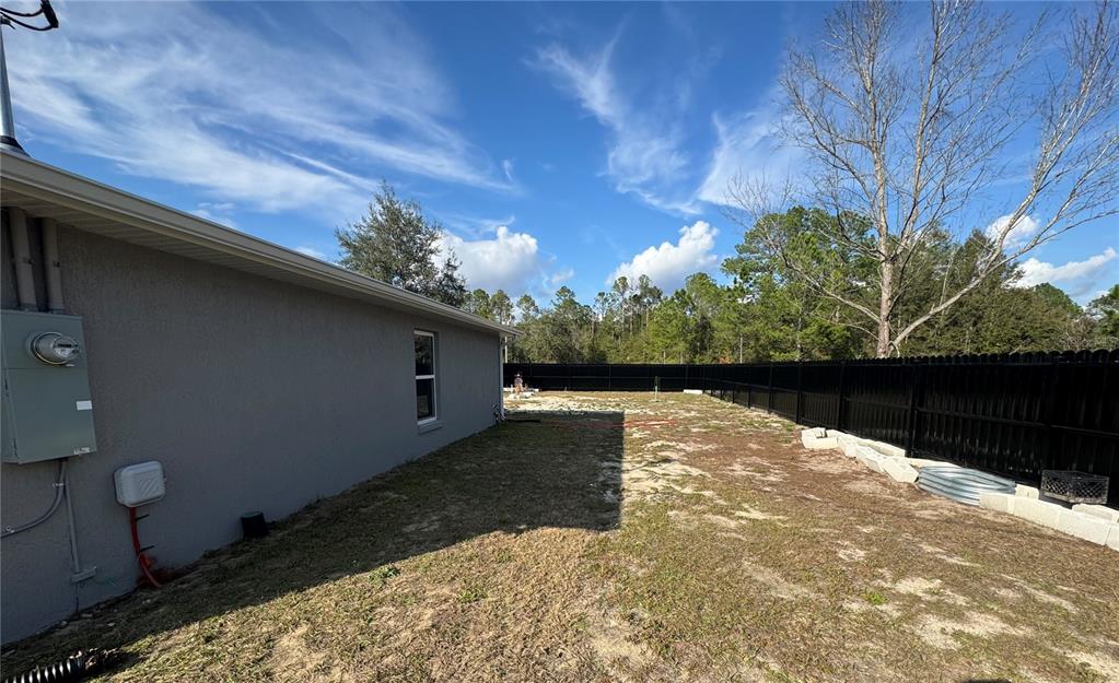 13183 Southwest 113th Place Dunnellon, FL 34432 - Photo 5 of 22 a backyard of a house with lots of green space