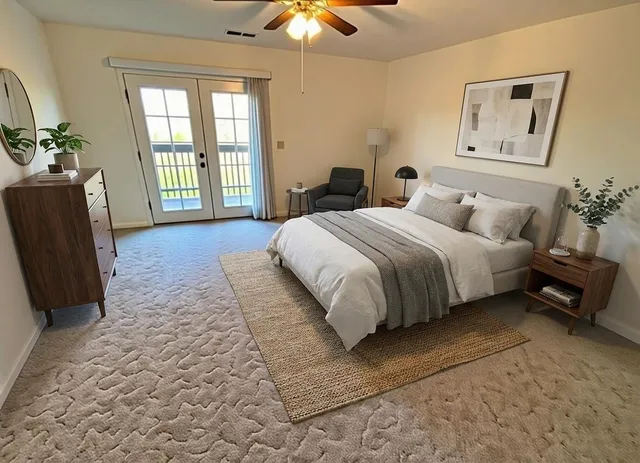 a spacious bedroom with a bed a couch and a chandelier