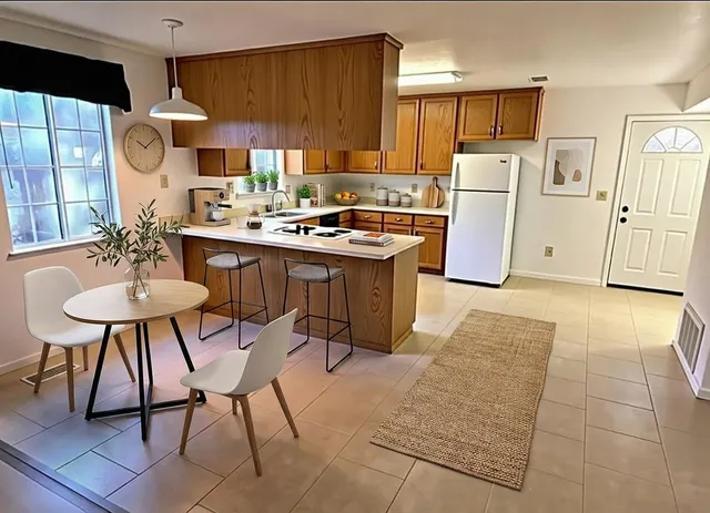 a kitchen with refrigerator and cabinets