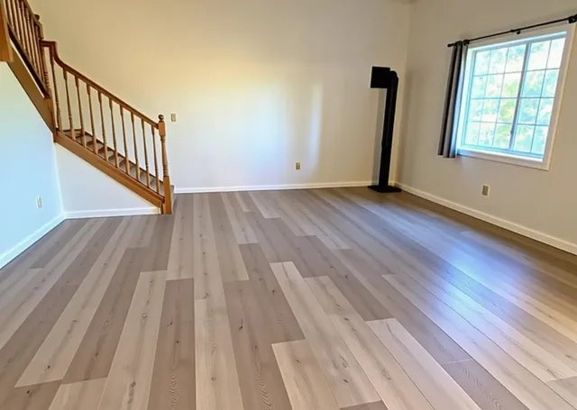 wooden floor in an empty room with a window