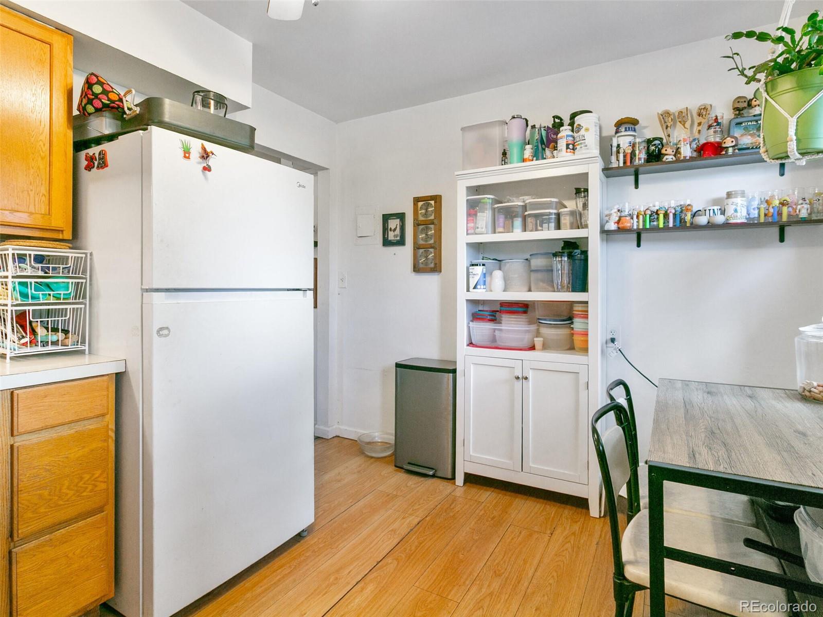 4615 Field Street Wheat Ridge, CO 80033 - Photo 11 of 39 a kitchen with refrigerator and table