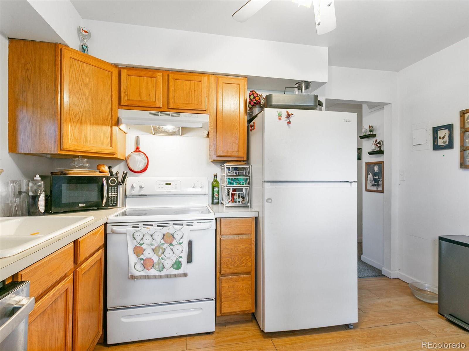 4615 Field Street Wheat Ridge, CO 80033 - Photo 12 of 39 a white refrigerator freezer sitting inside of a kitchen